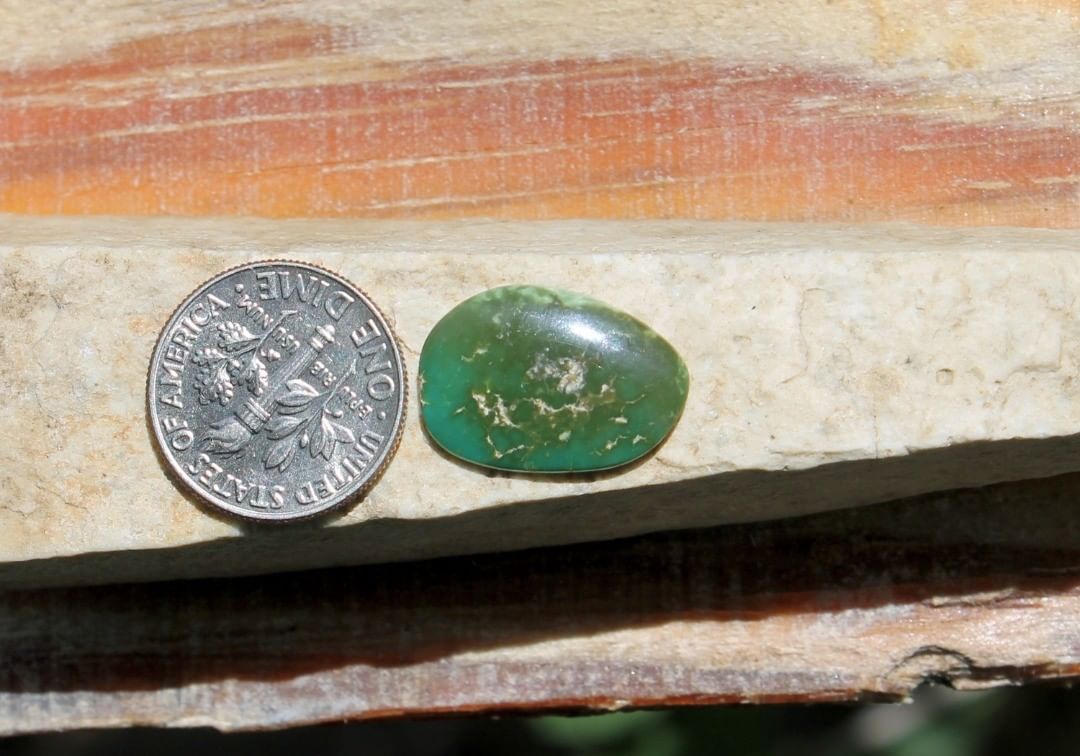 A natural dark green Stone Mountain Turquoise cabochon 
 $12 for 4.6 carats untreated & un-backed Nevada turquoise. 
