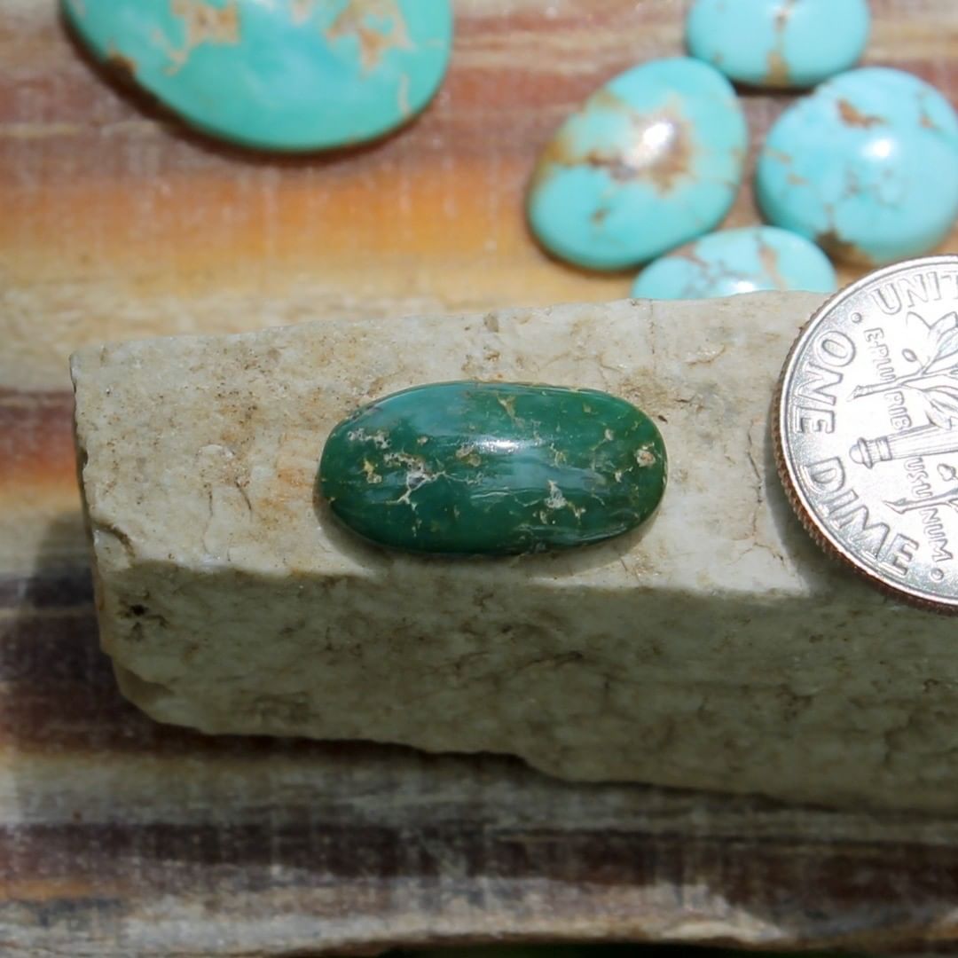 A natural dark green turquoise cabochon oval (Stone Mountain Turquoise)
 $9 for 3.0 carats untreated & un-backed Nevada turquoise. 
