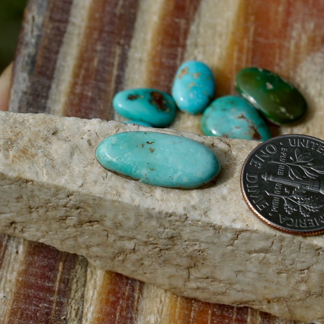 A natural light blue turquoise cabochon oval (Stone Mountain Turquoise)
 $14 for 5.2 carat untreated Nevada turquoise. This cabochon has a thin strip of natural hostrock backing.
