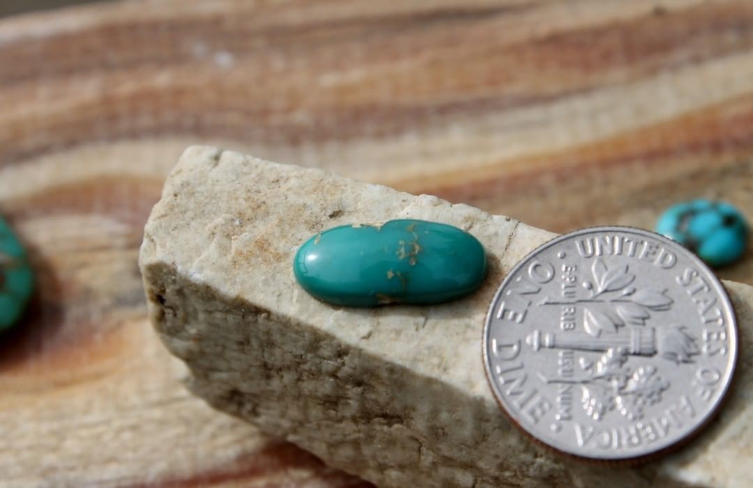 A natural teal-green turquoise cabochon oval (Stone Mountain Turquoise)
 $8 for 2.1 carat untreated & un-backed Nevada turquoise. 
