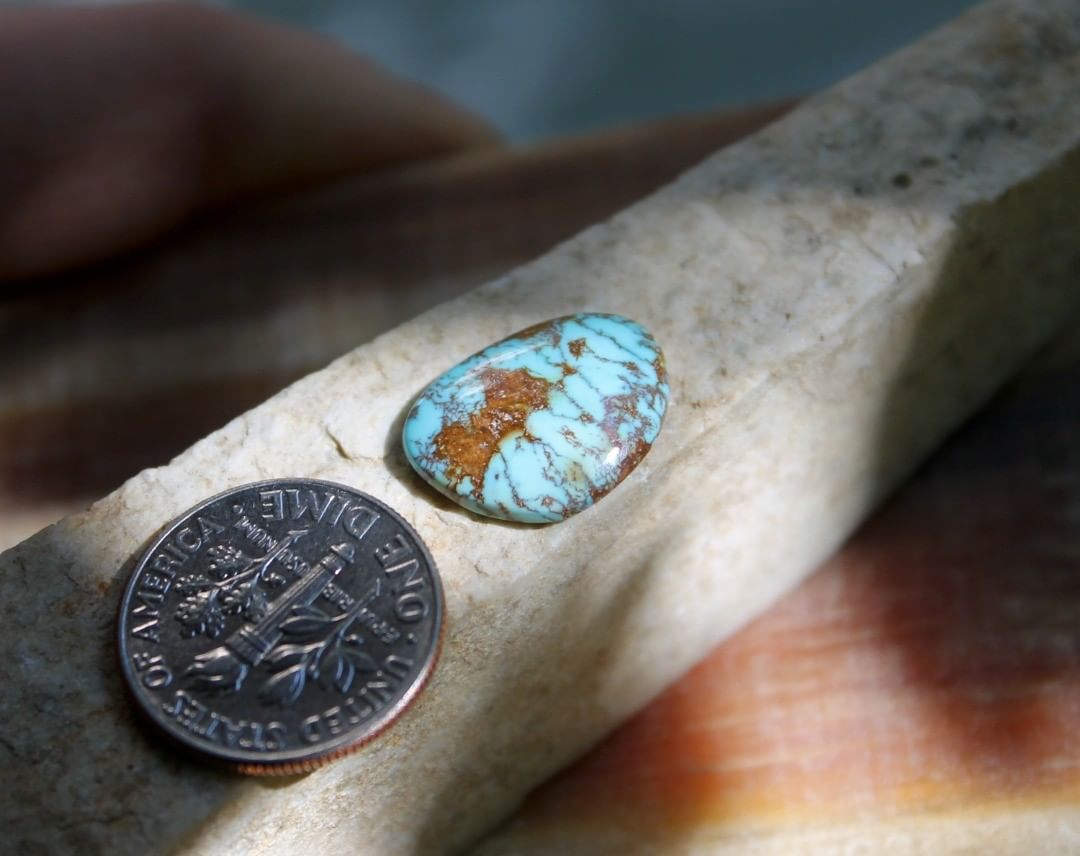 Natural blue Stone Mountain Turquoise cabochon w/ interesting red inclusions
 $12 for 4.3 carats untreated & un-backed Nevada turquoise.
