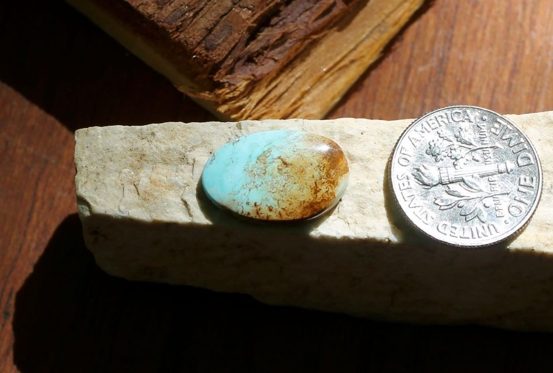 Natural blue Stone Mountain Turquoise cabochon w/ & red inclusions
 $11 for 4.0 carats untreated & un-backed Nevada turquoise. 
