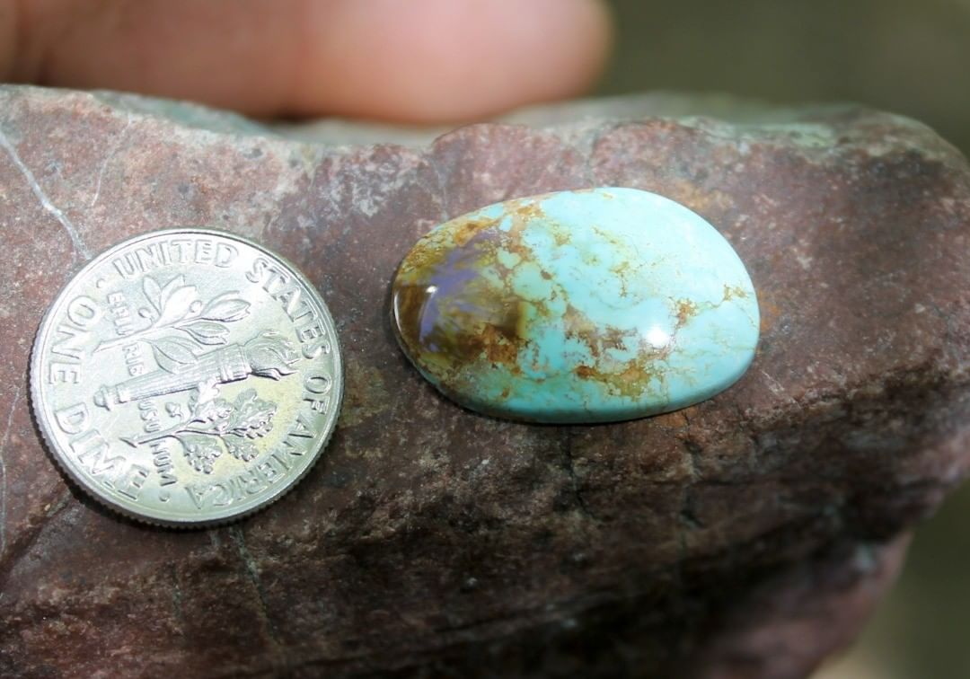 Natural blue Stone Mountain Turquoise cabochon w/ & red inclusions
 $26 for 8.9 carats untreated & un-backed Nevada turquoise. 
