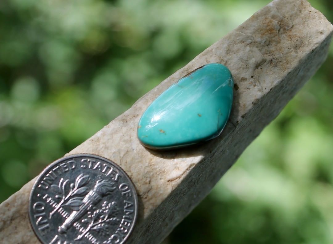 Natural blue Stone Mountain Turquoise turquoise cabochon
 $16 for 6.4 carat untreated Nevada turquoise. 
This cabochon has a thin strip of natural hostrock backing.
