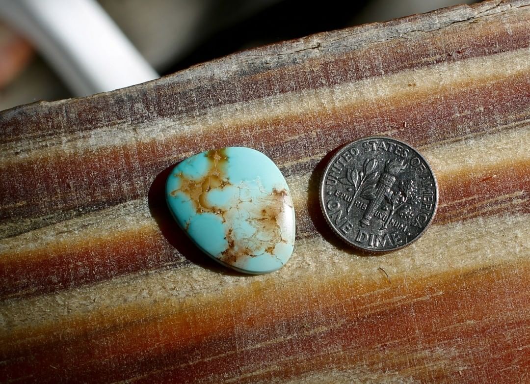 Natural light blue Stone Mountain Turquoise cabochon w/ red inclusions
 $23 for 8.0 carats untreated & un-backed Nevada turquoise.
