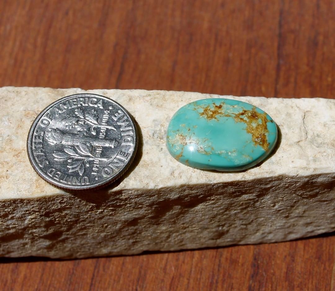 Natural light green Stone Mountain Turquoise cabochon w/ inclusions
 $18 for 6.5 carats untreated & un-backed Nevada turquoise. 
