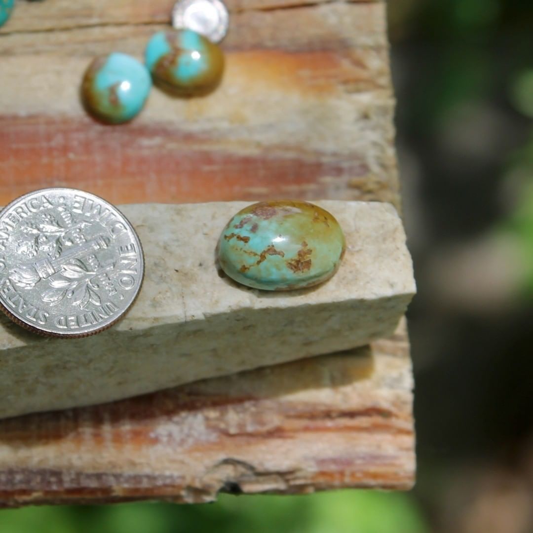 Natural Stone Mountain Turquoise cabochon w/ interesting inclusions
 $16 for 5.7 carats untreated & un-backed Nevada turquoise. 
