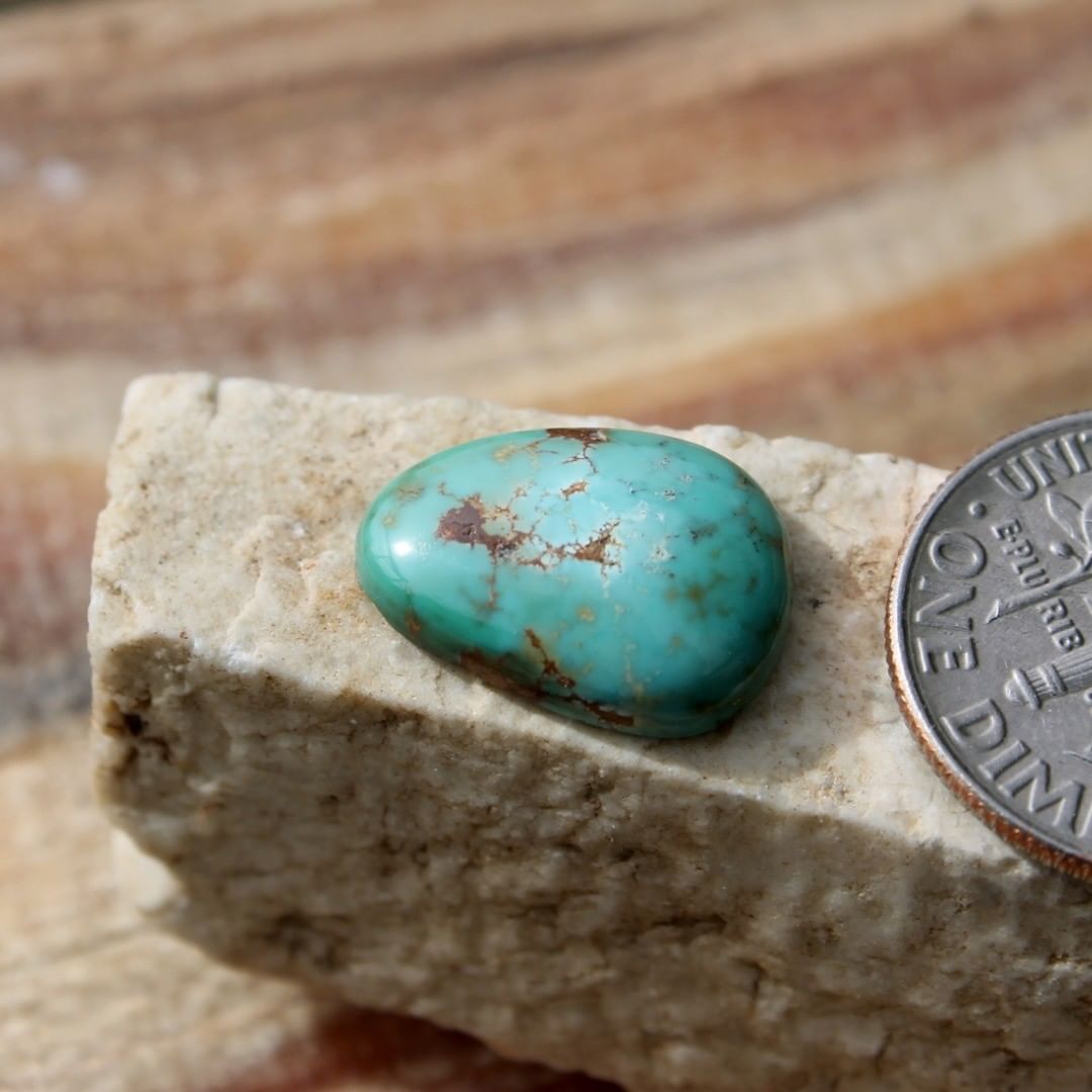 Natural Stone Mountain Turquoise cabochon w/ interesting patterns
 $12 for 4.3 carats untreated & un-backed Nevada turquoise. 
