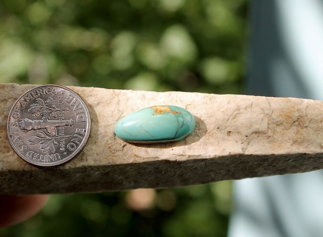 Natural Stone Mountain Turquoise cabochon w/ inclusions
 $12 for 4.2 carats untreated & un-backed Nevada turquoise. 
