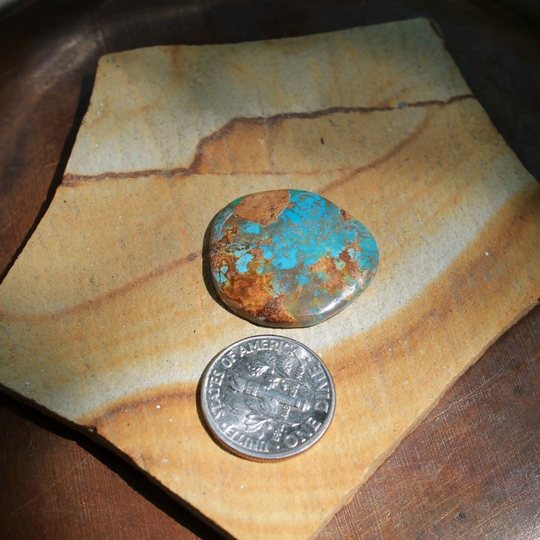 A cabochon in blue with red inclusions cut from a solid vein stone from Stone Mountain Mine.

$40 for 13.7 carats untreated & un-backed