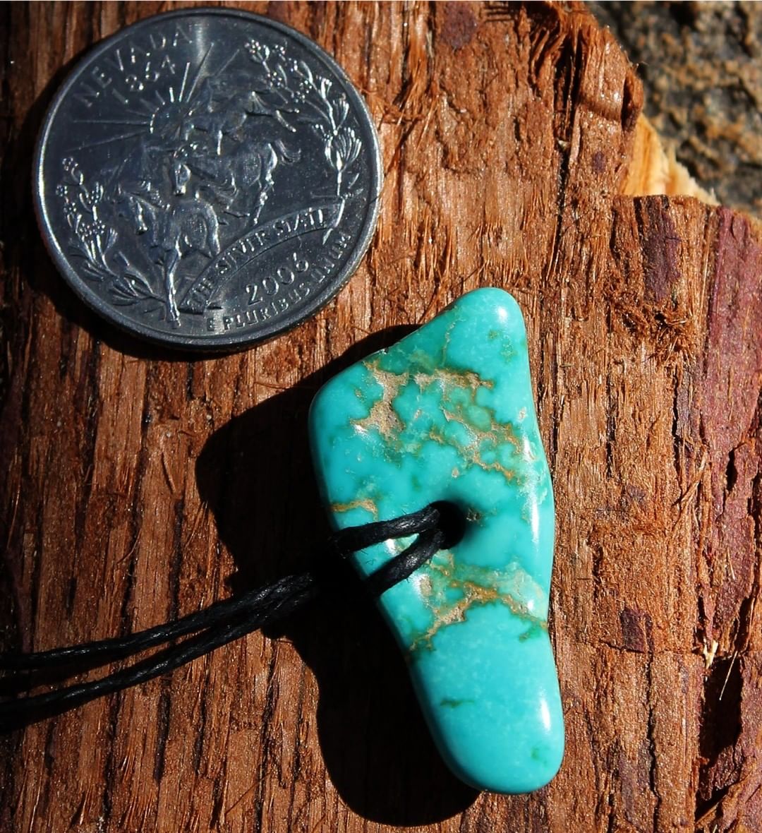 A hand polished natural blue Stone Mountain Turquoise focal bead 
 $65 for 19.7 carats
33x15x4.5 mm, 2.5 hole
Here is a Stone Mountain Turquoise vein nugget that has gone through a careful process of tumbling with several different polishing mediums. Then we drill the hole and widen it out before hand polishing the stone with a foredom. This stone was carefully selected for it’s ability to take a hole of this size without cracking.
