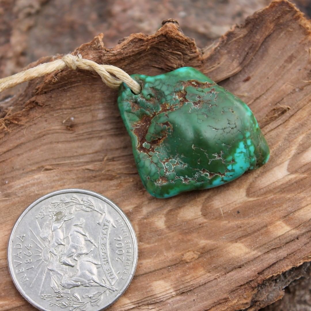 A large natural Stone Mountain Turquoise focal bead 
 $180 for 39.5 carats
31x24x6-12 mm, 2.2 mm hole
A large dual color turquoise nugget discovered at Stone Mountain Mine that has been tumbled extensively with numerous grits to smooth finish then carefully drilled for balanced hang.
