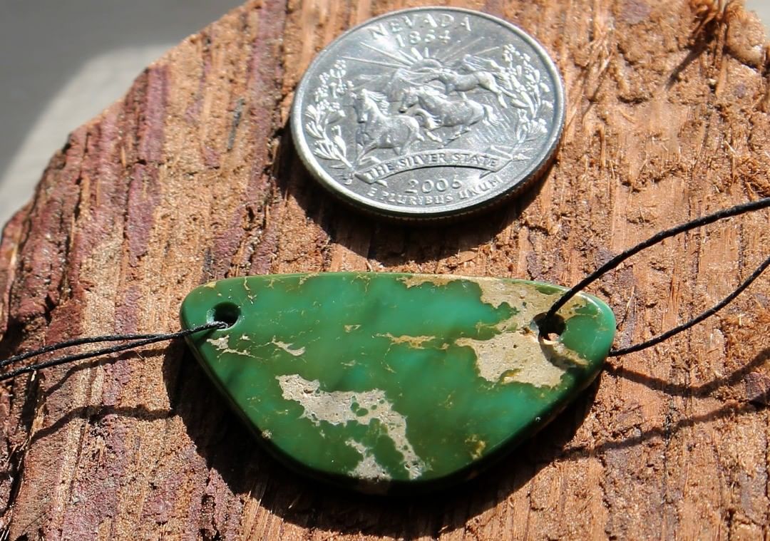 A natural double drilled green Stone Mountain Turquoise bead 
 $80 for 22 carats
37x21x3.5mm, holes are 2mm
