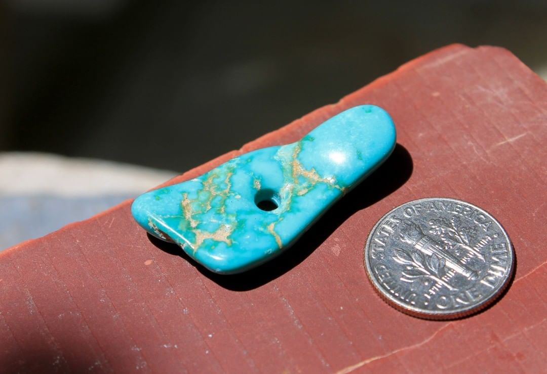 a turquoise foot?
A vivid blue focal bead with unique shape and inclusions.
 $75 for 19.7 carats untreated.
33x15x4.5 mm, 2.5 hole
A stunning carefully tumbled with several different polishing mediums then drilled, finally finish and clean-up