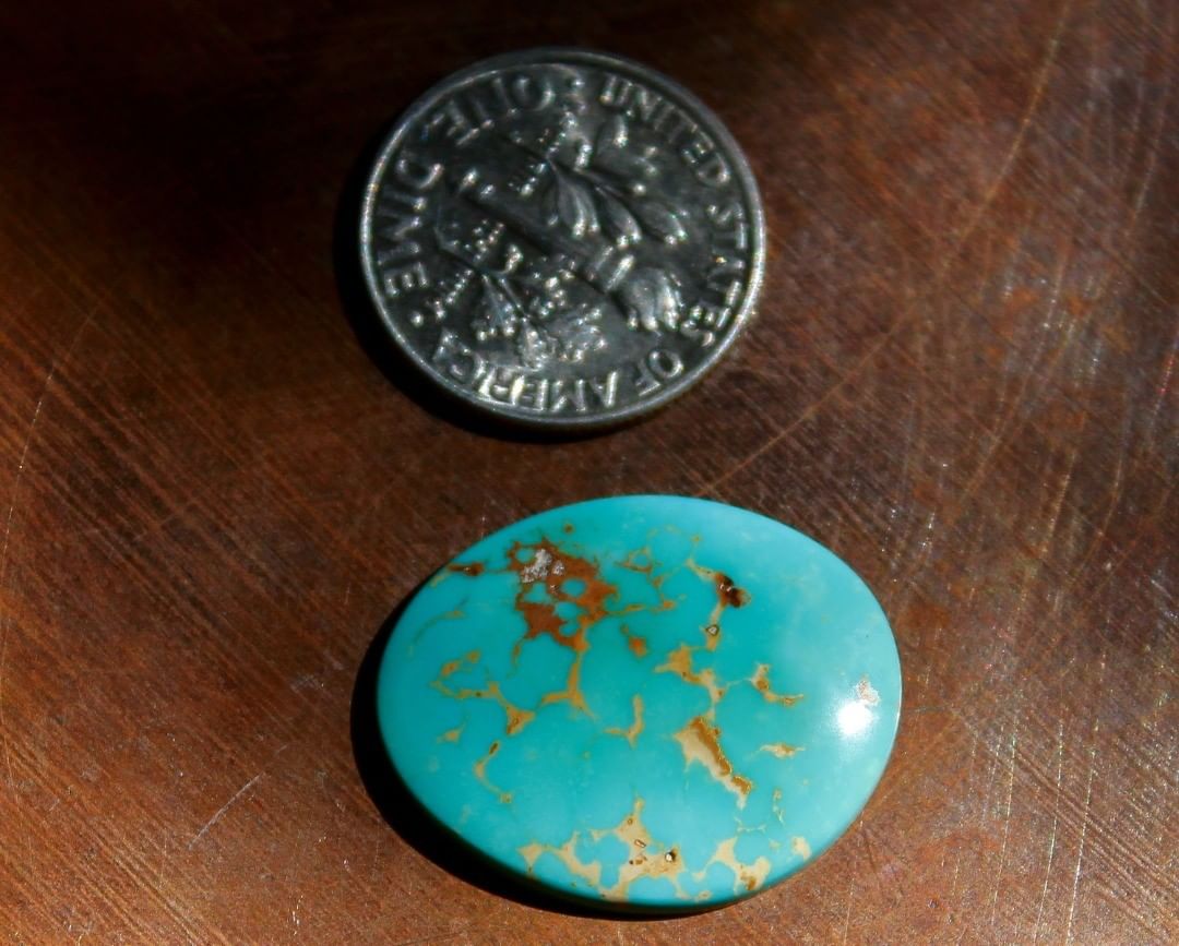 Natural blue Stone Mountain Turquoise cabochon w/ red matrix
 $26 for 9.4 carats untreated & un-backed Nevada turquoise. 
