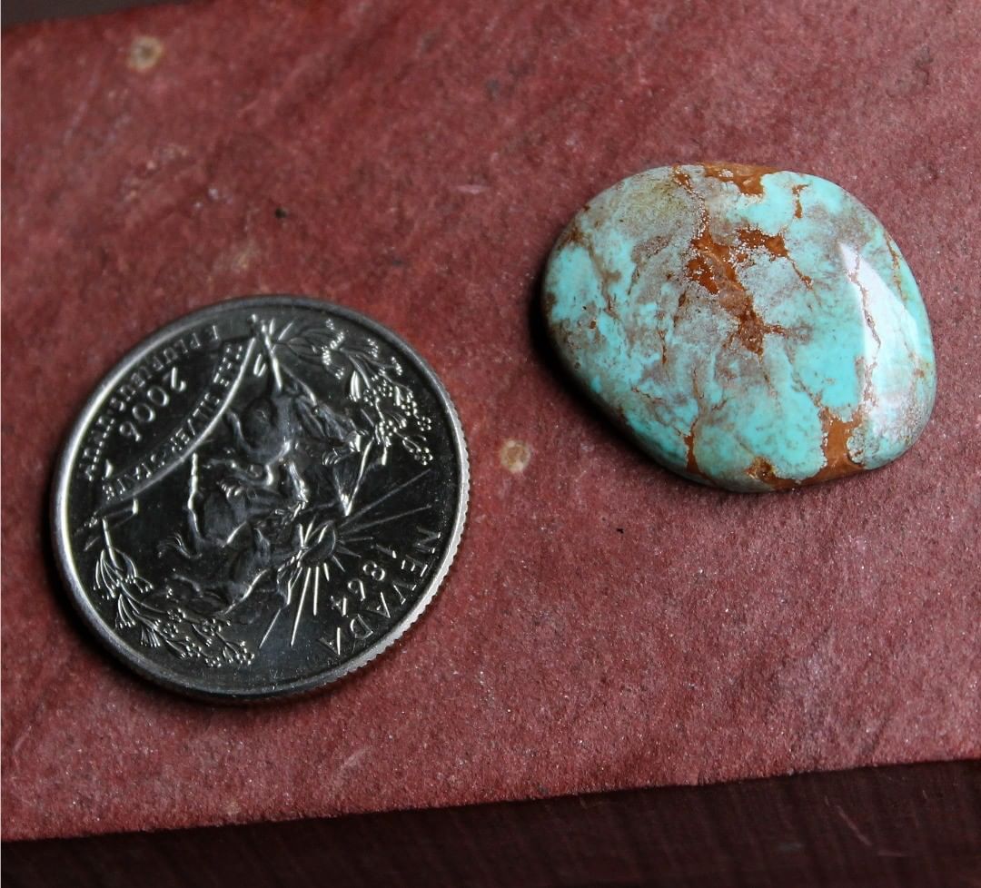 Natural blue Stone Mountain Turquoise w/ red inclusions 
 $35 for 12.1 carats untreated & un-backed Nevada turquoise.

