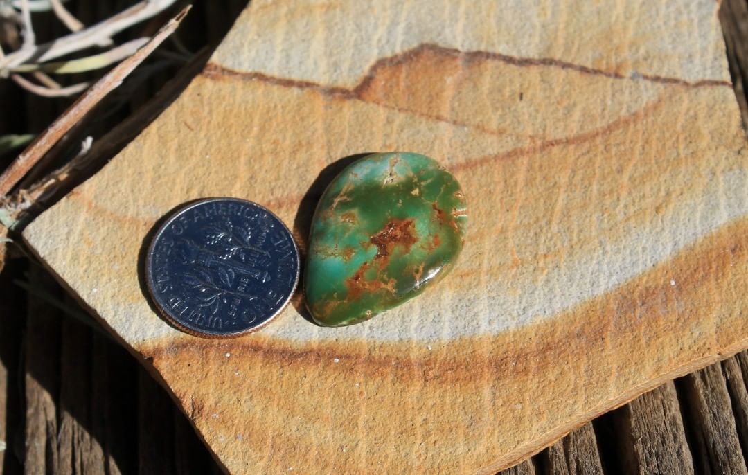 A green cabochon with dramatic color shifts. 

$34 for 13 carats un-backed & untreated