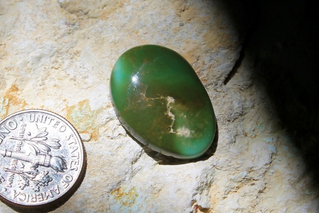 A green cabochon with mixed shades. This natural was cut from a single turquoise nugget, retaining it’s natural shape

$36 for 13.4 carats un-backed & untreated