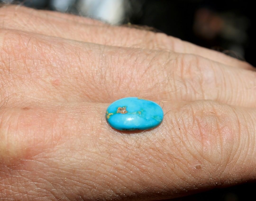 A natural blue turquoise cabochon with red matrix. 

$12 for 3.8 carats untreated & un-backed Nevada turquoise