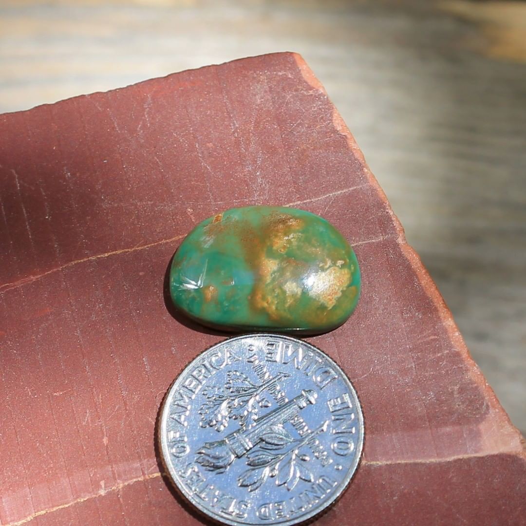 A natural green cabochon with red inclusions Claim or DM $16 for 5.8 carats untreated & un-backed Nevada turquoise