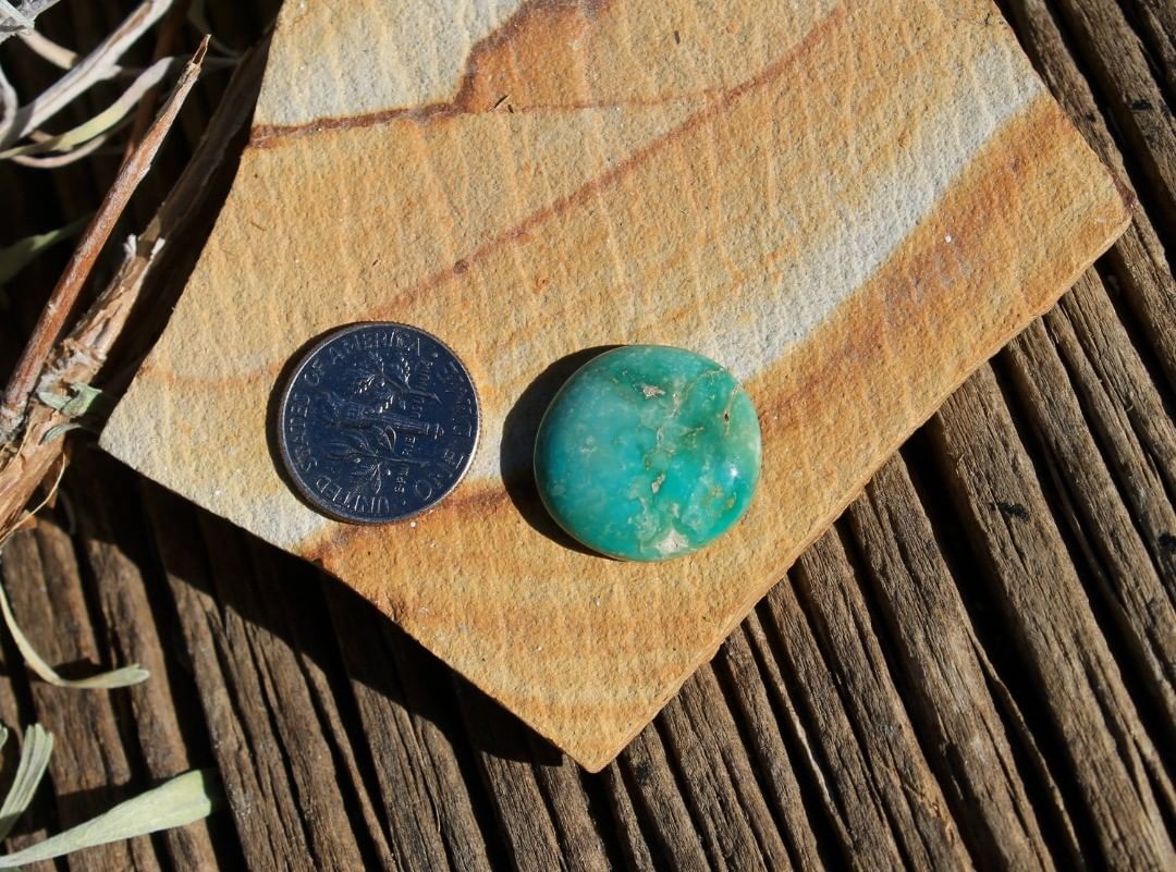 A round green cabochon with a swirly color pattern. 

$38 for 14.1 carats un-backed & untreated